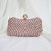 gold evening bag showing pearl strap and diamante clasp