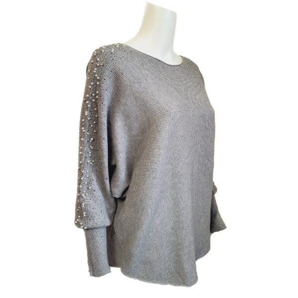 Grey jumper with pearl and sparkle sleeve side view