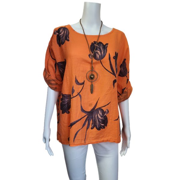 orange top with 3/4 sleeves and floral design