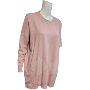 Long line jumper in pale pink. Jumper has pockets and long sleeves.