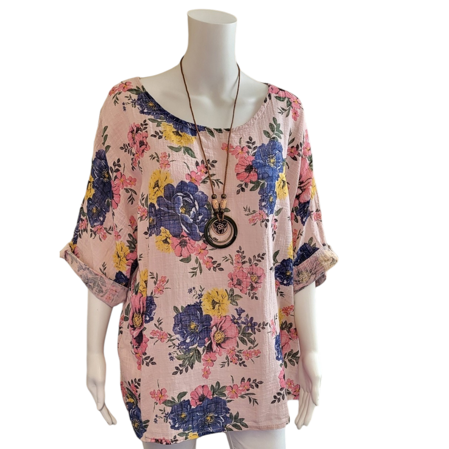 pale pink cotton top with large blue and yellow flowers. image shows necklace that is provided too.