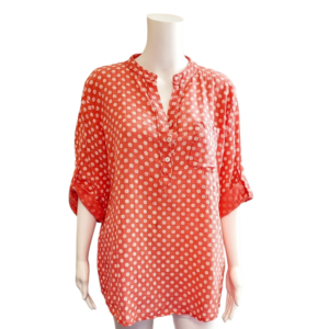 Orange shirt with white polka dots, 3/4 sleeves and grandad collar.