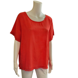 Red short sleeved top with scoop neck and trim detailing around the sleeve and bottom edges