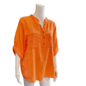 Orange shirt with 3 buttons and turned up sleeves. Shirt has embroidered breast pockets and back section