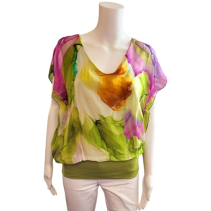 lime green, pink and yellow abstract top in a silky material. top has a v neck and elasticated band of coloured material around the bottom. short sleeves.