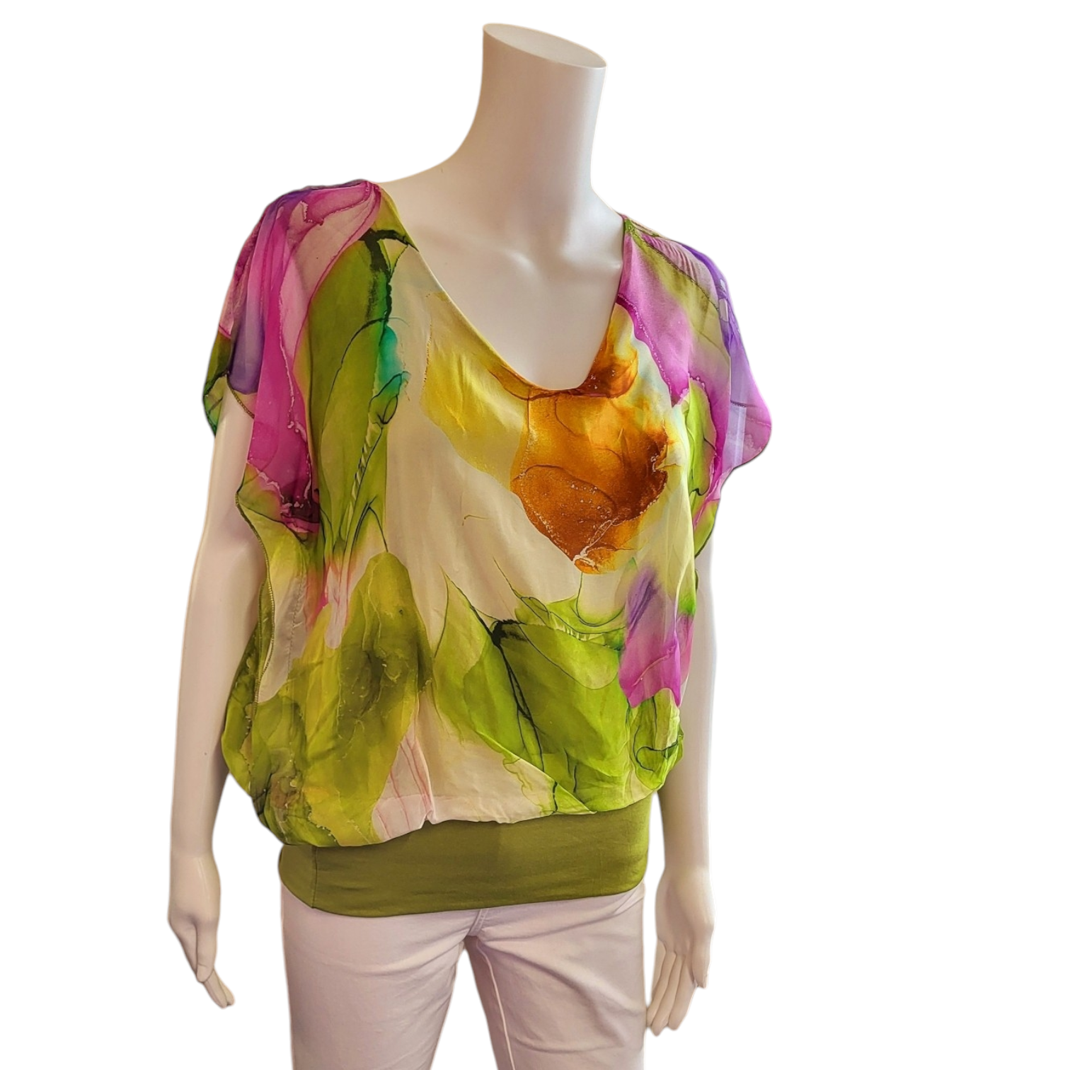 lime green, pale pink and cream coloured top in a colourful abstract design. top has short sleeves and v neck