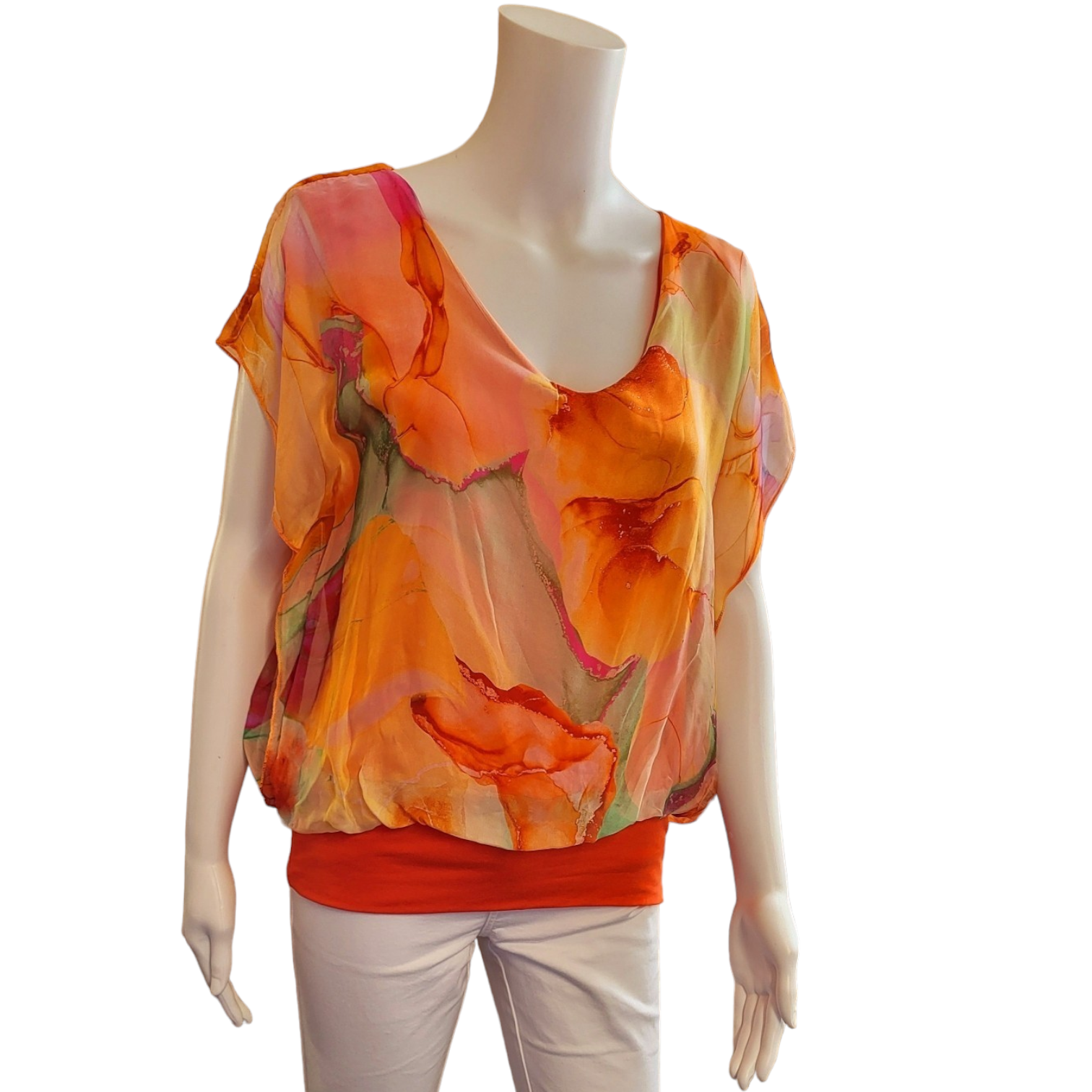 orange top in a silky material with orange elasticated band around the bottom. short sleeves and v neck, abstract design