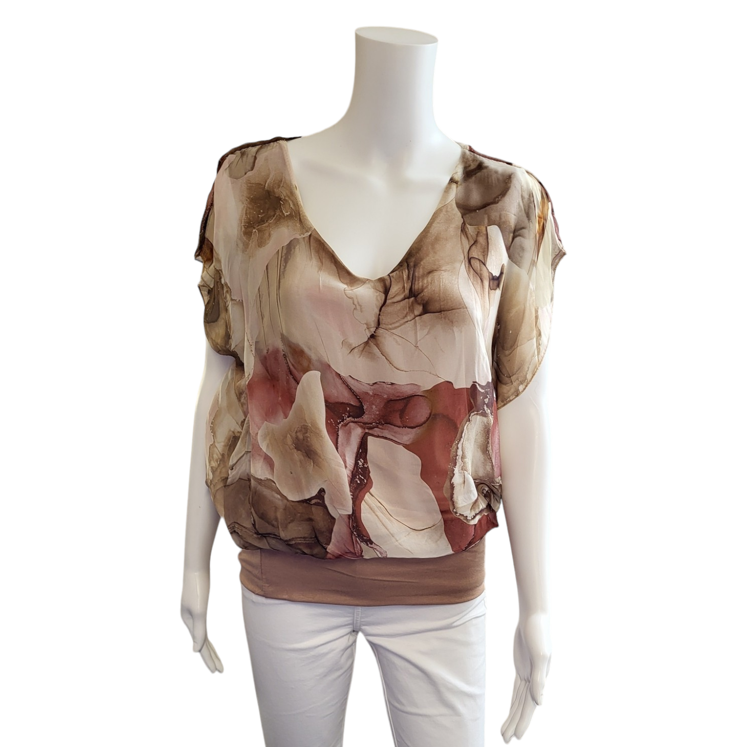 silky v neck top with short sleeves and a v neck. abstract design in brown and cream/beige